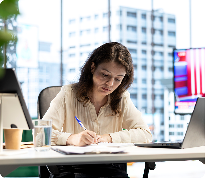 Writer working on an article in a modern office with city view