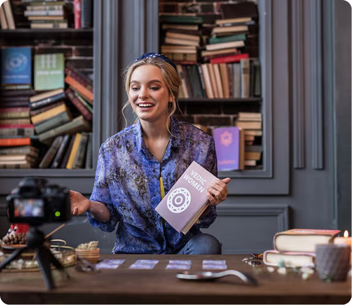 Author smiling and presenting her book on camera in a creative studio