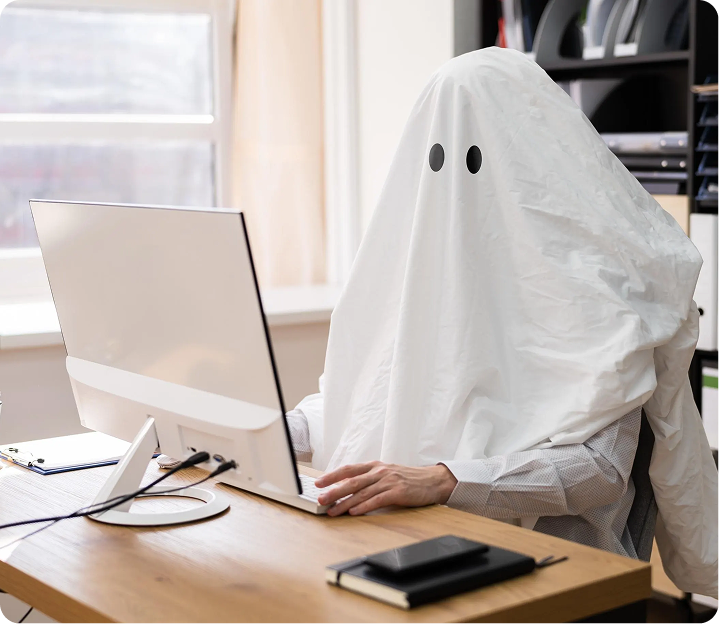 Ghost character typing on a computer at a desk
